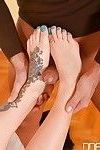 Foot fetish scene with a tattooed girl with long legs Yuffie Yulan doing footjob