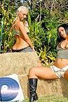Bikini clad hot lesbian women in boots kissing & toying pussy outdoors