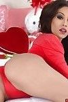 Brunette Latina babe Valentine freeing huge tits and tattoos from lingerie