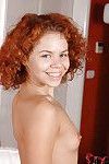Curly-haired redhead sweetie in jeans undressing and exposing her goods
