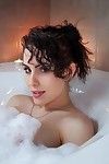 Brunette amateur Katie Banks showing her pink pussy in tub by candlelight