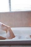 Brunette amateur Katie Banks showing her pink pussy in tub by candlelight