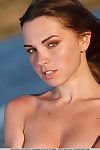 Skinny young Anita E strips at the beach to flaunt firm tits and bald pussy