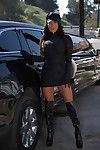 Latina babe August Taylor posing in chauffeur\'s uniform and knee high boots