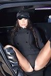 Latina babe August Taylor posing in chauffeur\'s uniform and knee high boots
