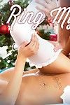 Stocking attired August Ames giving blowjob in front of Christmas tree