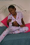 Teen ebony Dazy is lying naked and playing with nice big boobs