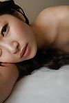 Asian teen Yuma Yoneyama undressing and spreading her lower lips in close up